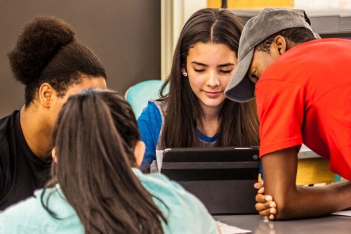 Student around a laptop.